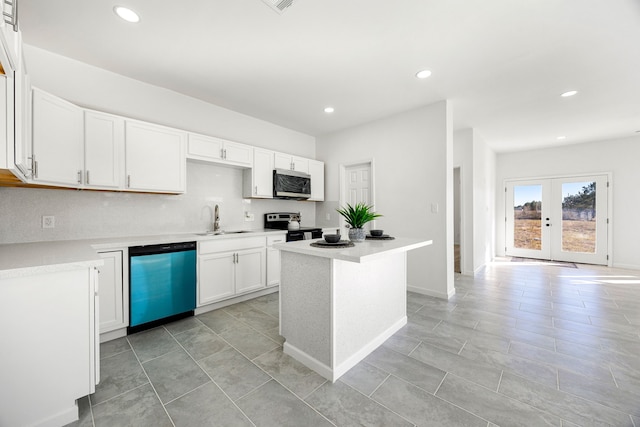 kitchen featuring sink, dishwasher, white cabinetry, range with electric stovetop, and a kitchen island