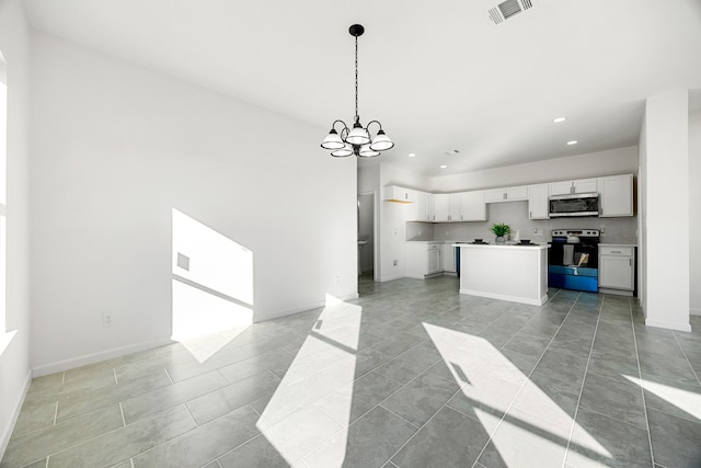 kitchen with a kitchen island, appliances with stainless steel finishes, pendant lighting, white cabinetry, and a notable chandelier