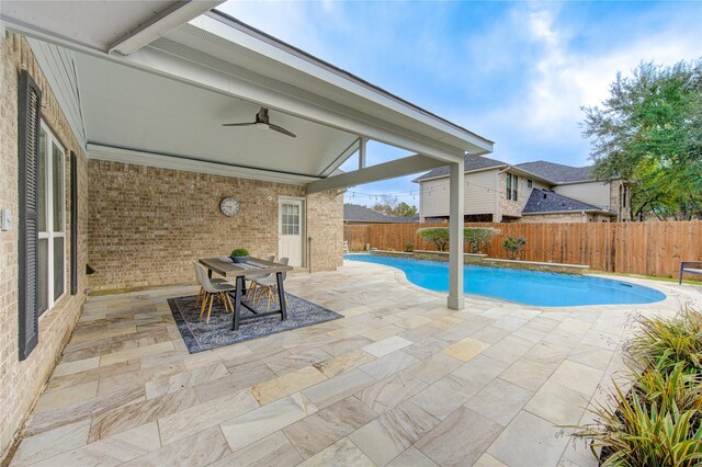 view of pool with ceiling fan and a patio