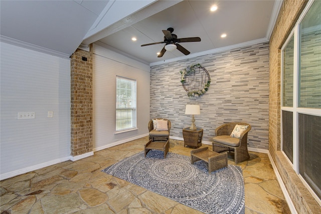 sitting room with ceiling fan and ornamental molding