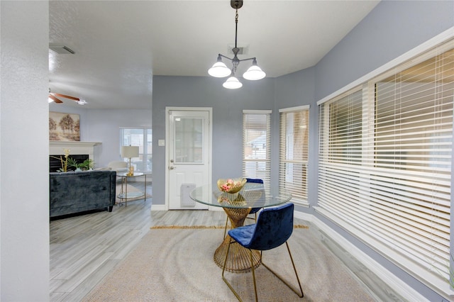 dining area featuring a chandelier and light wood-type flooring