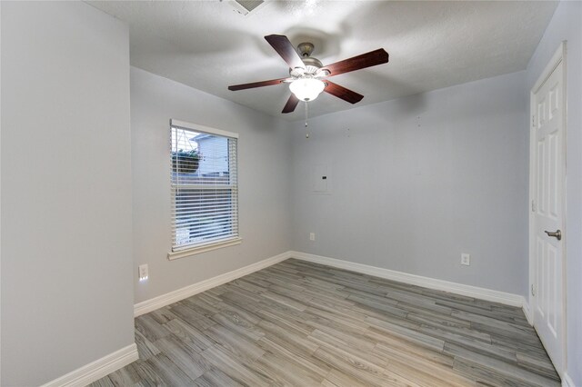 unfurnished room featuring ceiling fan and light wood-type flooring