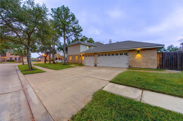 view of front property featuring a garage and a front lawn