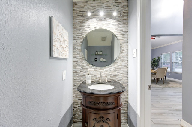 bathroom featuring crown molding and vanity