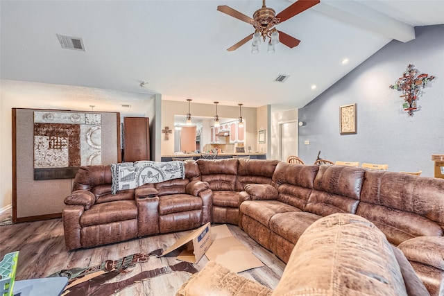 living room featuring vaulted ceiling with beams, hardwood / wood-style floors, and ceiling fan