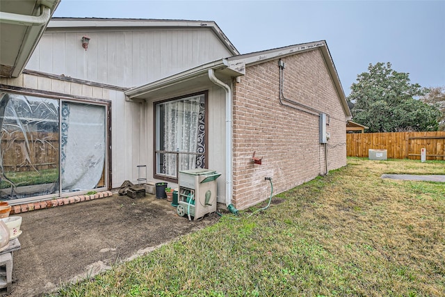 view of side of home with a lawn