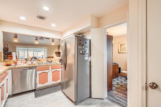 kitchen featuring stainless steel appliances, sink, and white cabinets