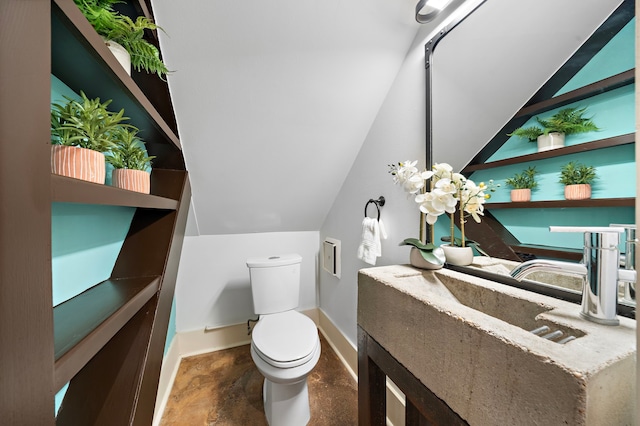 bathroom with vanity, lofted ceiling, and toilet