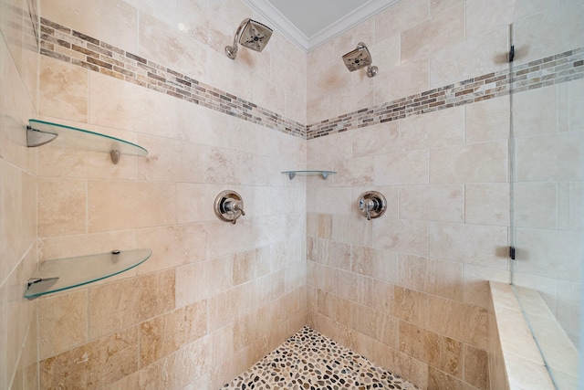 bathroom featuring a tile shower and ornamental molding