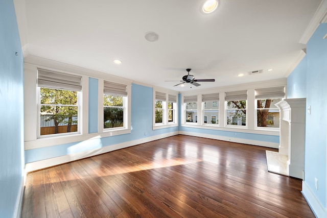 unfurnished living room featuring ornamental molding, dark hardwood / wood-style floors, and ceiling fan