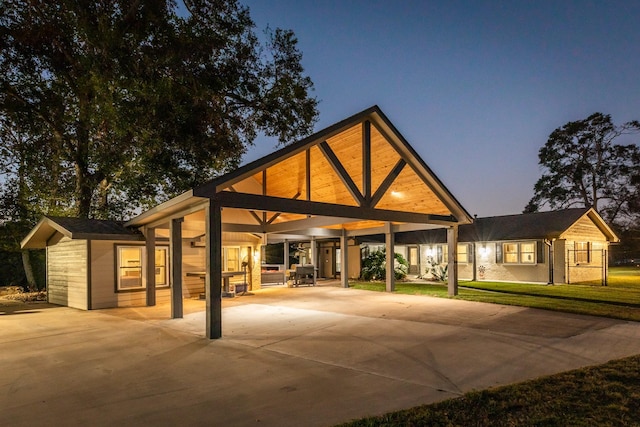 exterior space featuring a carport and a lawn