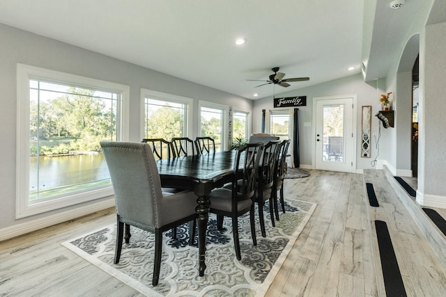 dining area featuring light hardwood / wood-style flooring and vaulted ceiling