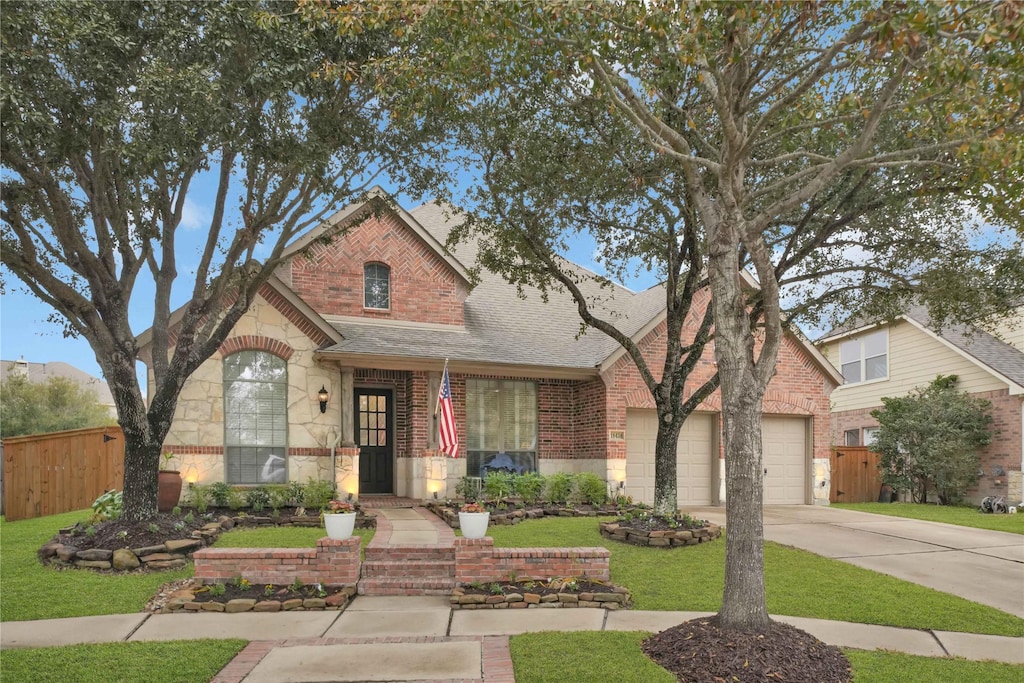 view of front of house with a garage and a front lawn