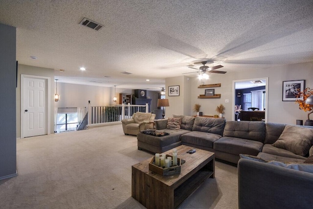 living room featuring light colored carpet and a textured ceiling