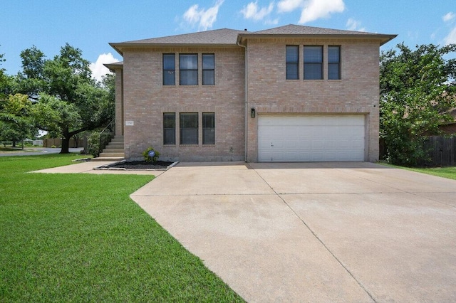 view of front facade with a garage and a front lawn