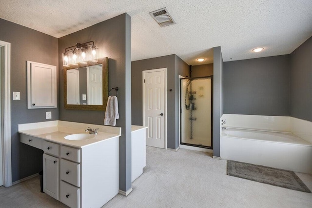 bathroom featuring vanity, a tub to relax in, and a textured ceiling