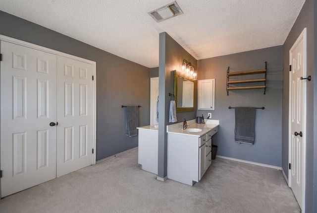 bathroom featuring vanity and a textured ceiling