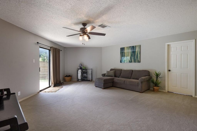 carpeted living room with a textured ceiling and ceiling fan