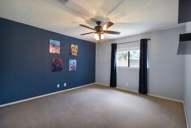 unfurnished room with ceiling fan, carpet, and a textured ceiling