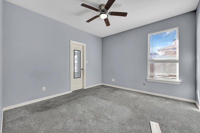 carpeted spare room with ceiling fan