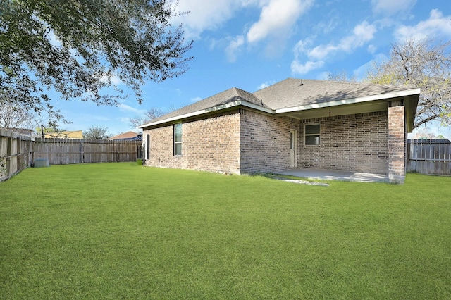 back of house featuring a patio and a yard