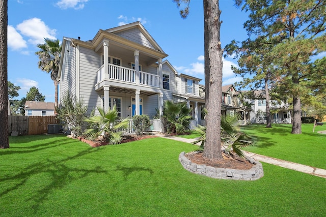 view of front of home with central AC, a front lawn, and a balcony