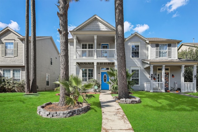 view of front of home with a porch, a balcony, and a front yard