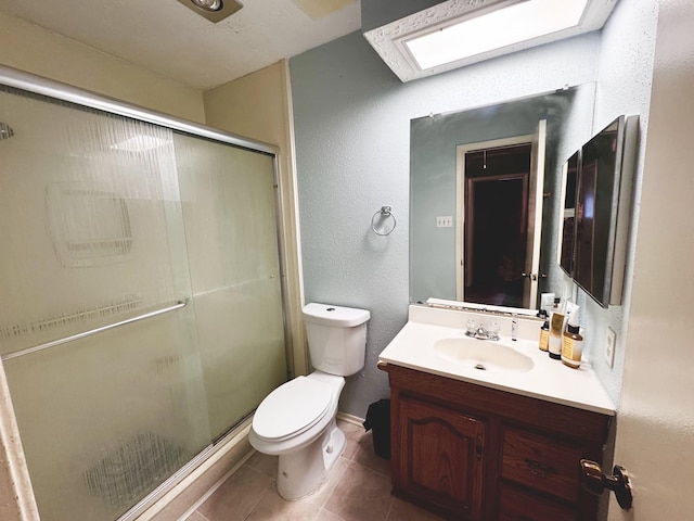 full bath with toilet, a stall shower, a skylight, and vanity