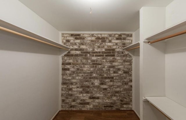 walk in closet featuring dark wood-style flooring