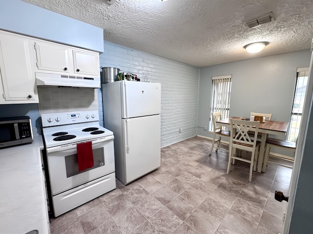 kitchen featuring light countertops, visible vents, white cabinets, white appliances, and under cabinet range hood