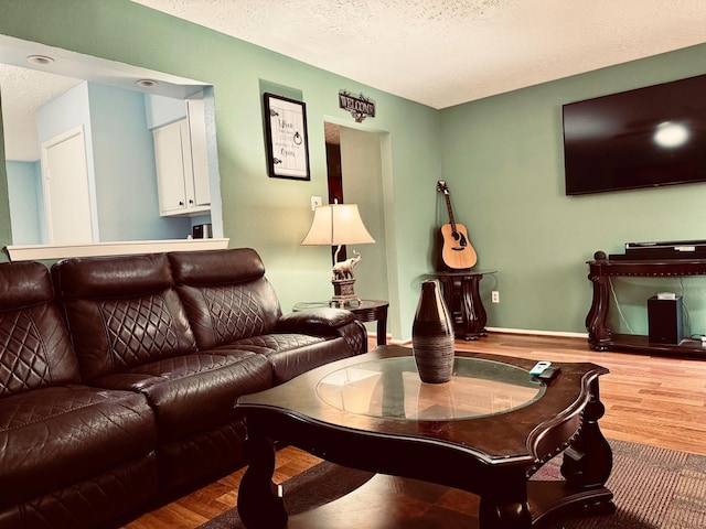 living area featuring a textured ceiling and wood finished floors