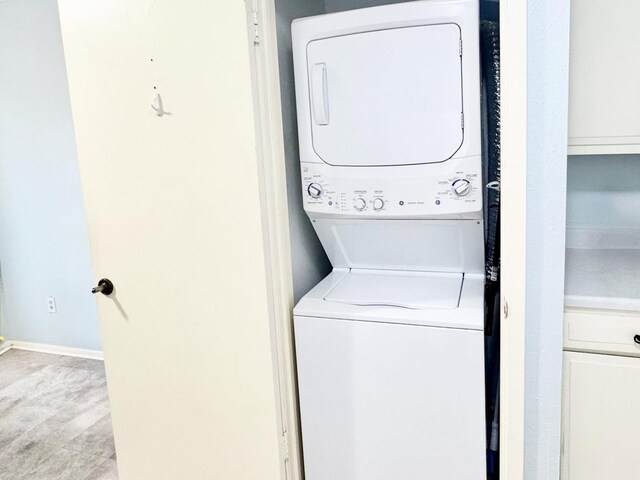 laundry room featuring stacked washer and dryer