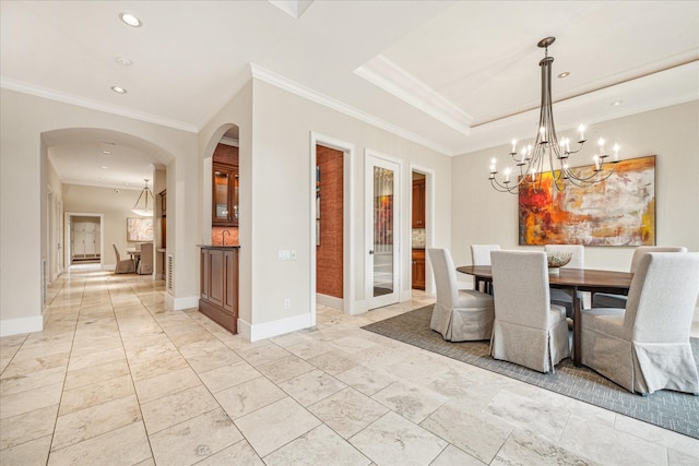 unfurnished dining area featuring a raised ceiling and crown molding