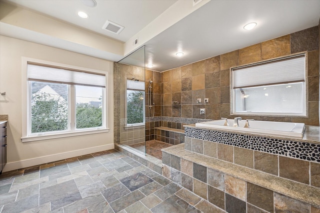 bathroom with independent shower and bath and vanity