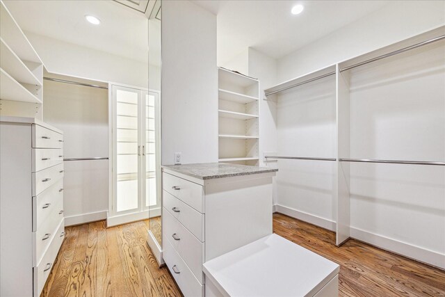 spacious closet featuring light hardwood / wood-style floors