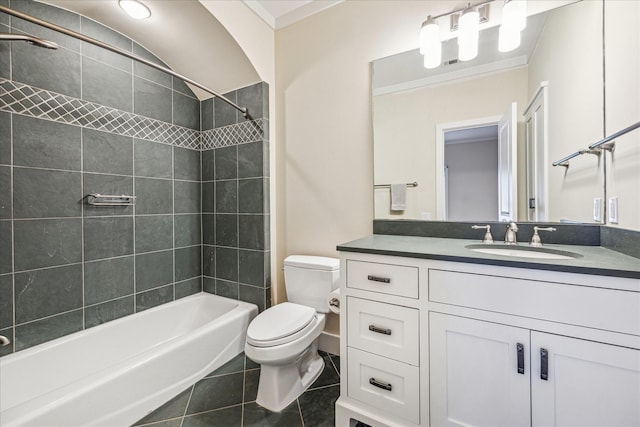 full bathroom with tiled shower / bath combo, vanity, toilet, crown molding, and tile patterned floors