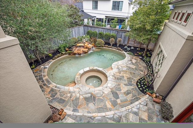 view of pool with an in ground hot tub