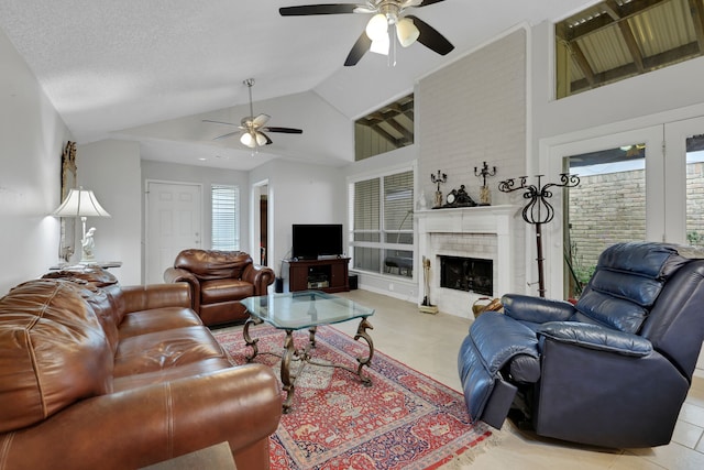 living room featuring ceiling fan, a textured ceiling, and high vaulted ceiling