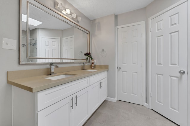 1912 Trixie Ln, Houston, TX 77042 - bathroom featuring double vanity, tile patterned floors, and a tile shower