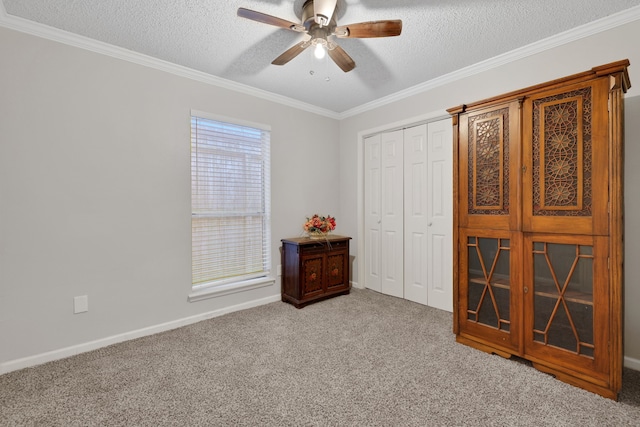 carpeted bedroom featuring ornamental molding, a closet, and a textured ceiling