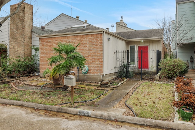 1912 Trixie Ln, Houston, TX 77042 - view of front facade with brick siding, roof with shingles, a gate, and fence
