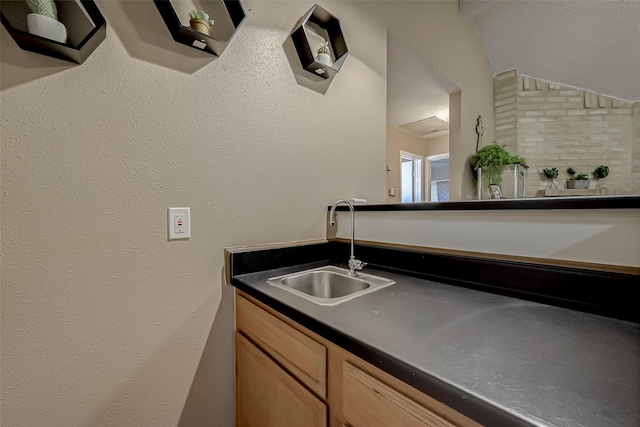 interior space with sink and light brown cabinets