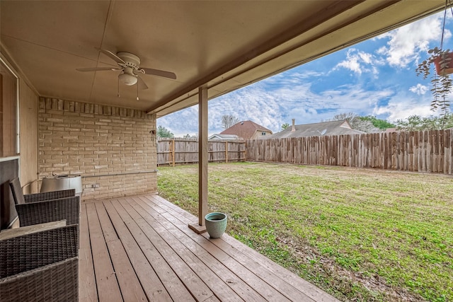 deck featuring a yard and ceiling fan