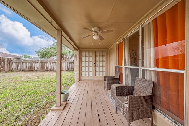 wooden deck featuring a yard, french doors, and ceiling fan