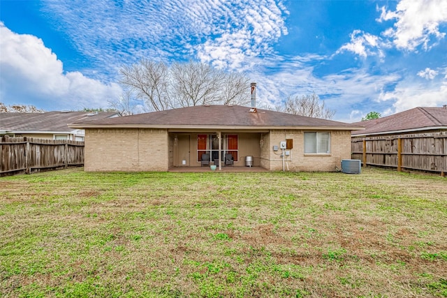 rear view of house with a patio area and a lawn