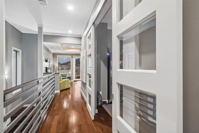 corridor featuring crown molding and dark hardwood / wood-style flooring