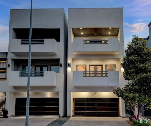 contemporary home featuring a garage and a balcony