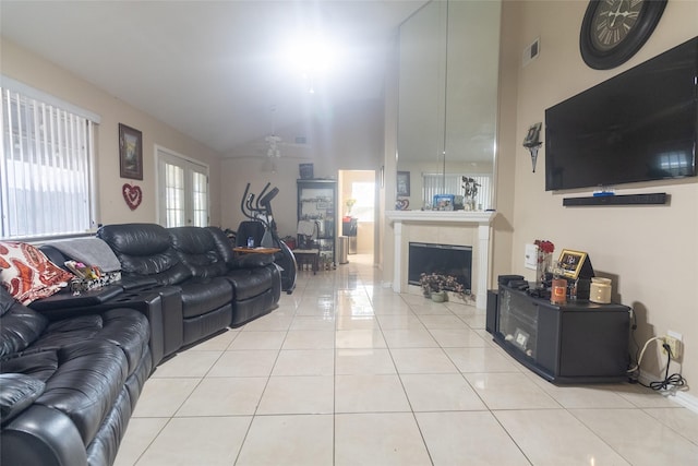 tiled living room featuring lofted ceiling and a tile fireplace