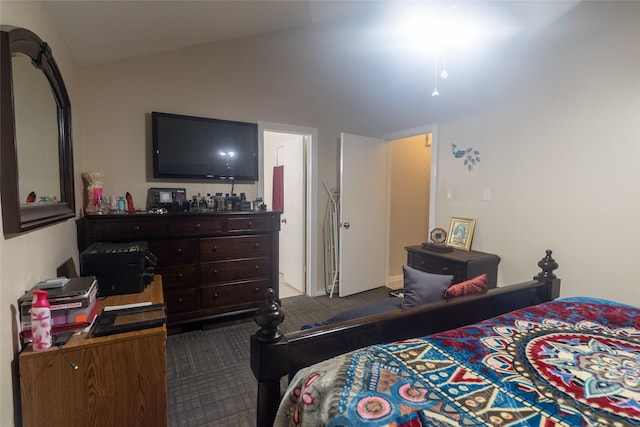 bedroom featuring vaulted ceiling and dark colored carpet