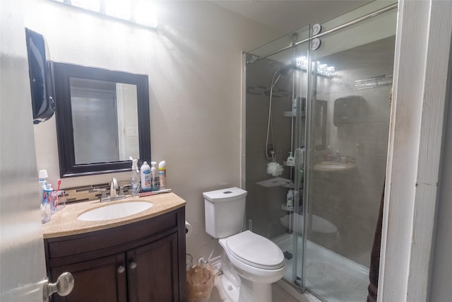 bathroom with vanity, an enclosed shower, and toilet